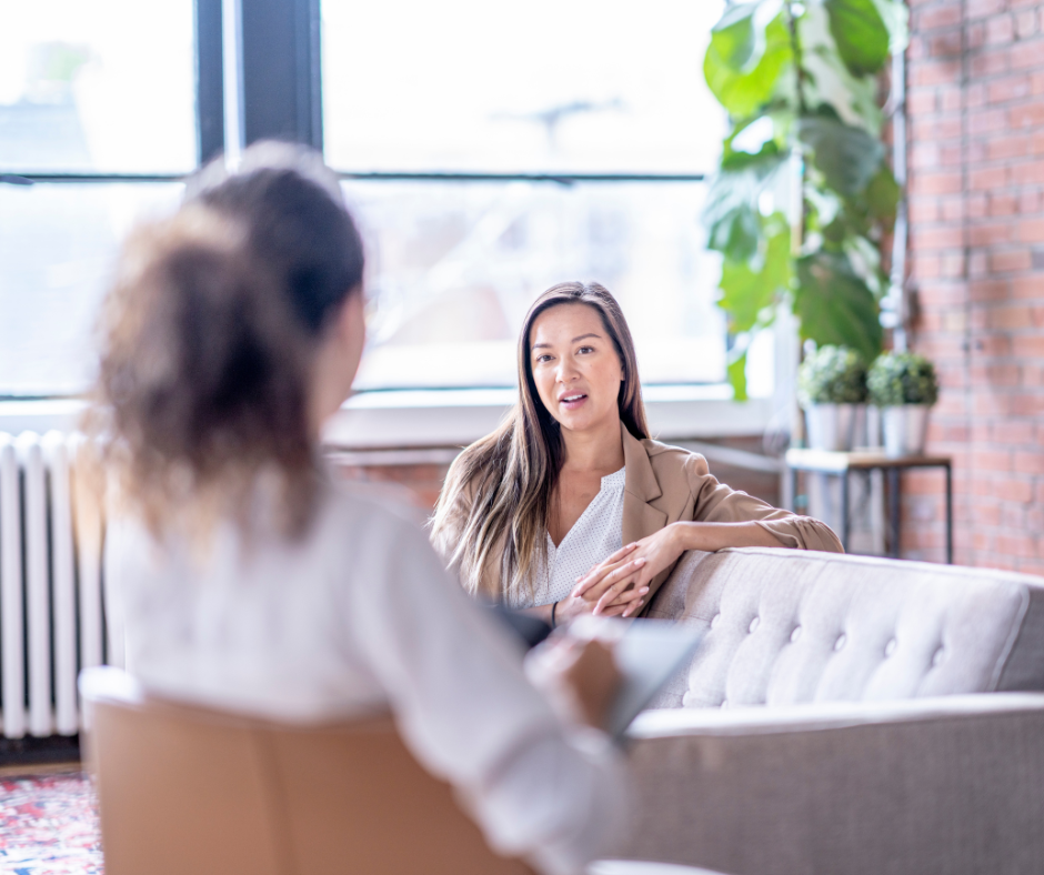 A coach listening to a client, momentarily lost in thought — illustrating how coaches can drift out of presence.